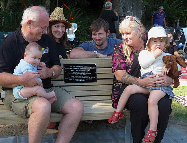 The Stevens whānau at the unveiling of the seat dedicated to Nicky’s life, placed on the banks of the Waikato River at the spot where he found peace. Left to right: Dave with moko Johnny, Tony’s partner Georgie, Tony, Jane with moko Fallon.